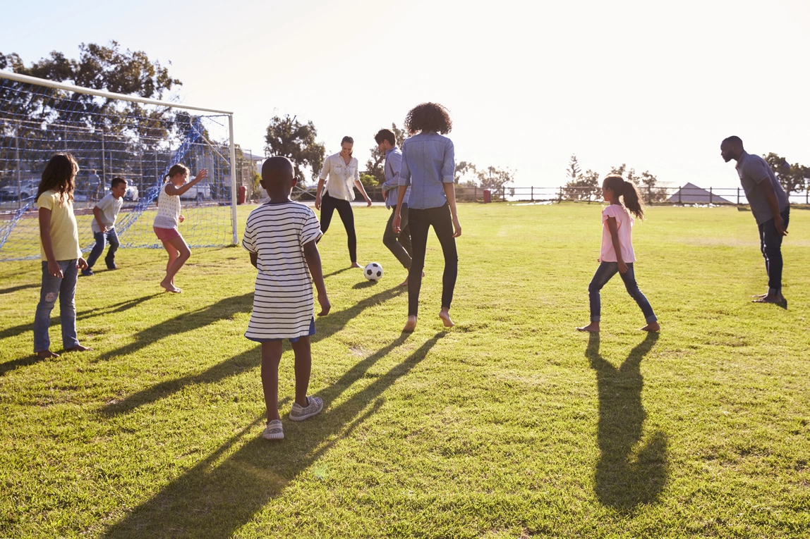 two-young-families-playing-football-with-their-chi-2023-11-27-05-13-30-utc Home
